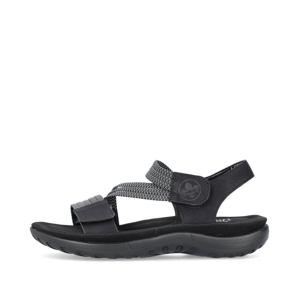 Black Rieker women´s strap sandals 64870-00 with a hook and loop fastener. Outside of the shoe.