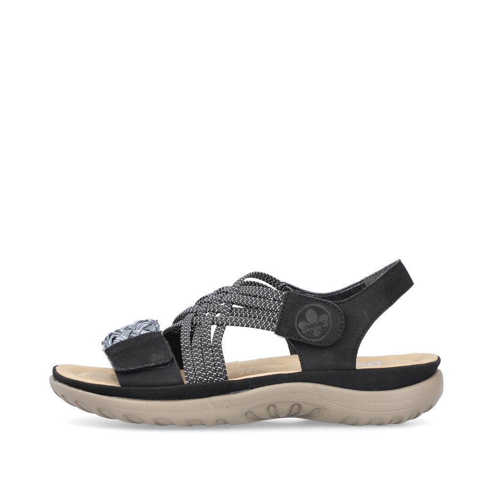 Night black Rieker women´s strap sandals 64889-00 with a hook and loop fastener. Outside of the shoe.