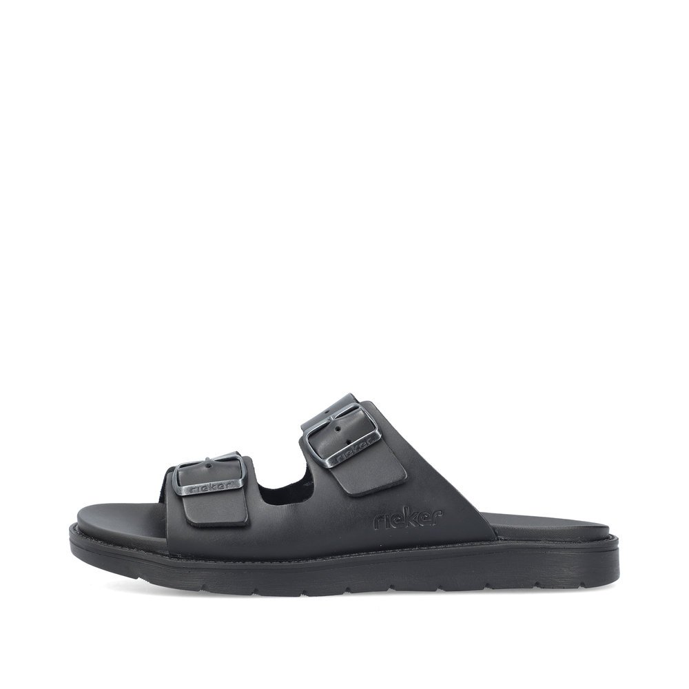 Jet black Rieker men´s mules 24290-00 with buckle as well as comfort width G 1/2. Outside of the shoe.