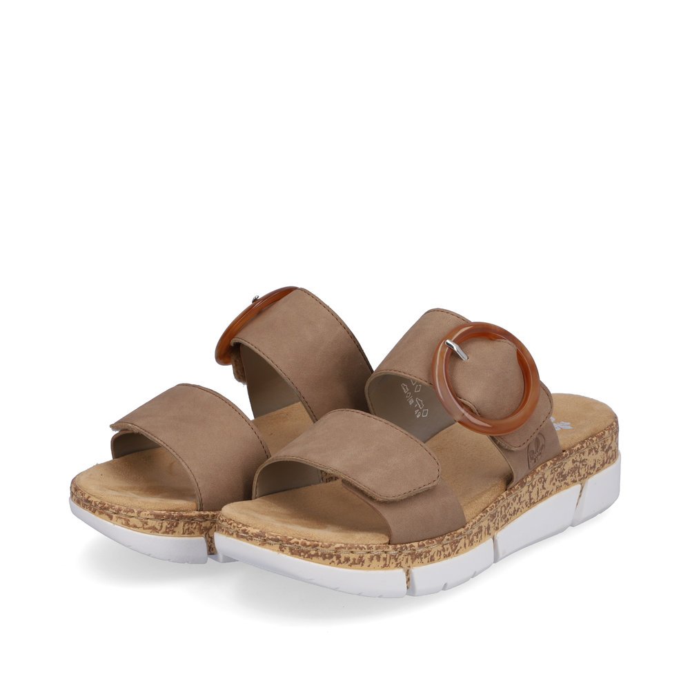 Beige Rieker women´s mules V2392-62 with a hook and loop fastener. Shoes laterally.