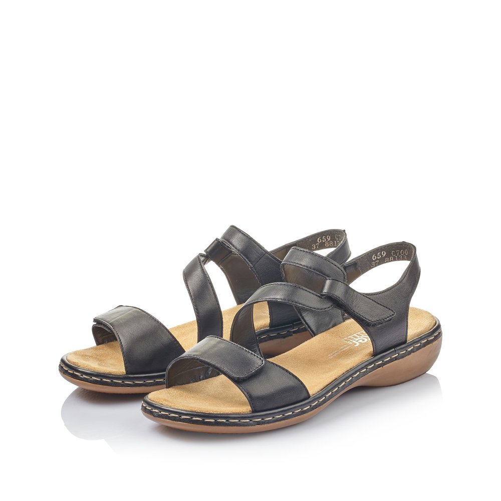 Jet black Rieker women´s strap sandals 659C7-00 with a hook and loop fastener. Shoes laterally.
