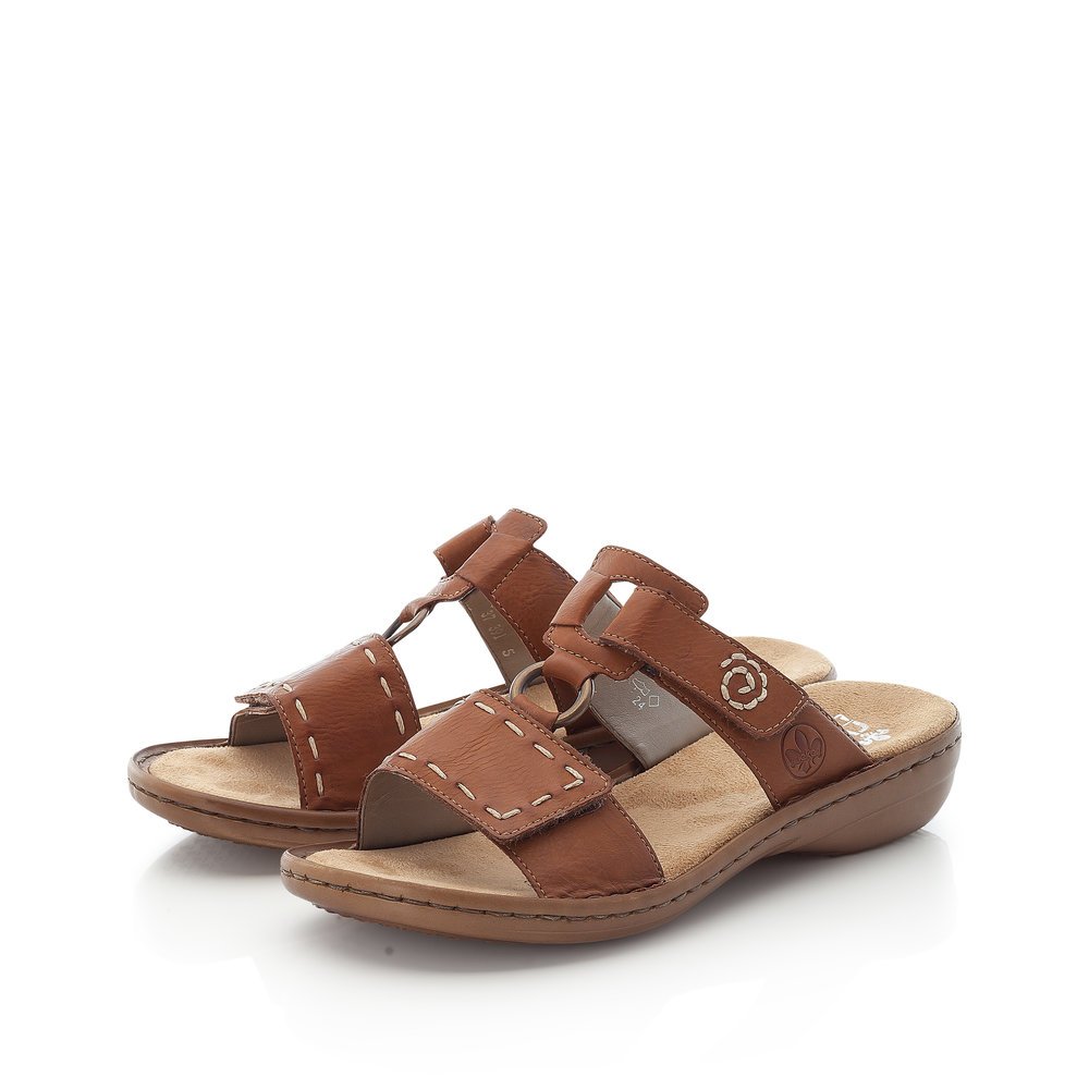 Coffee brown Rieker women´s mules 60822-24 with a hook and loop fastener. Shoes laterally.