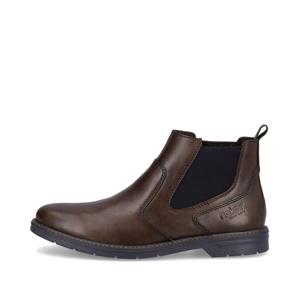 Dark brown Rieker men´s Chelsea boots 13092-25 with a zipper as well as profile sole. The outside of the shoe