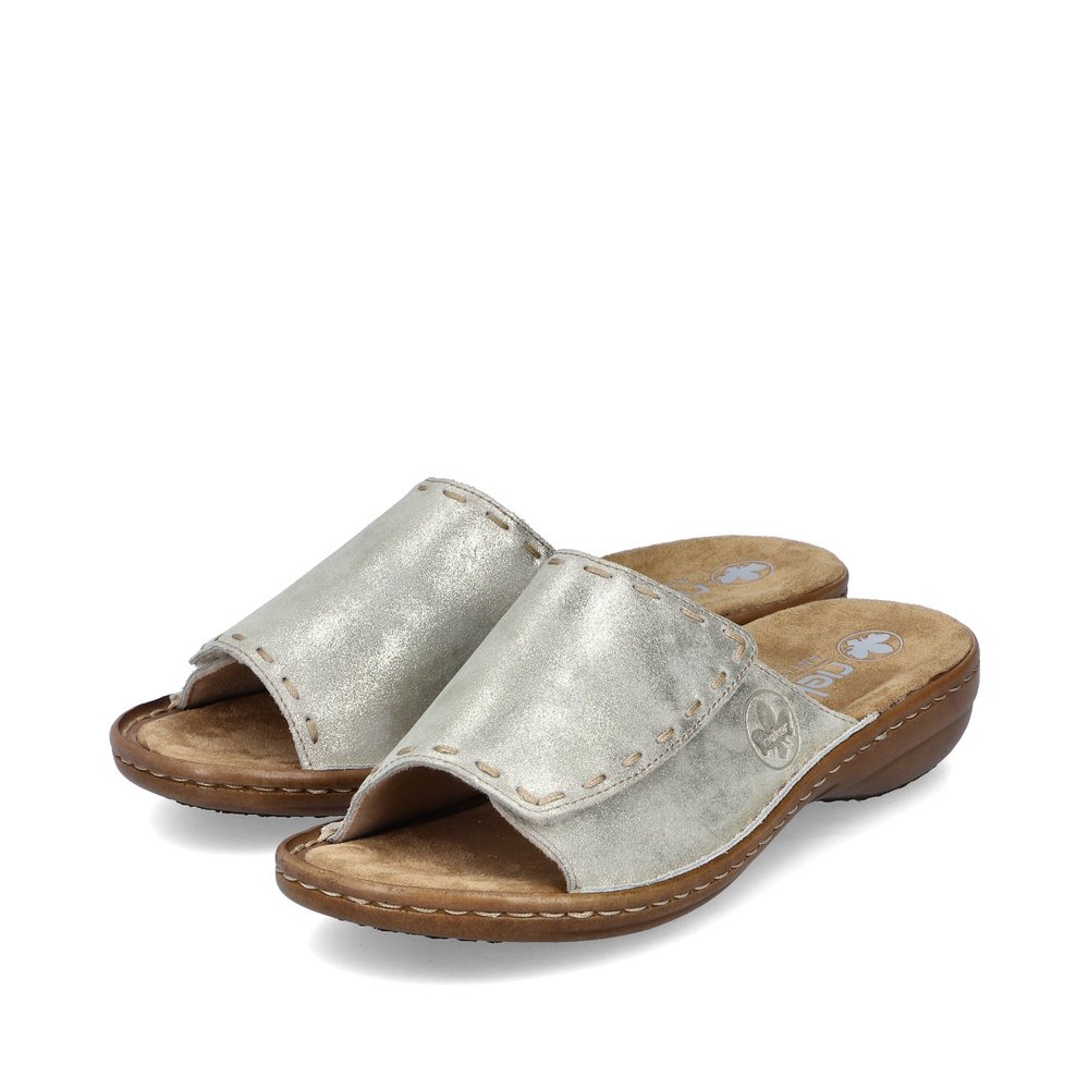 Light beige Rieker women´s mules 60896-62 with a hook and loop fastener. Shoes laterally.