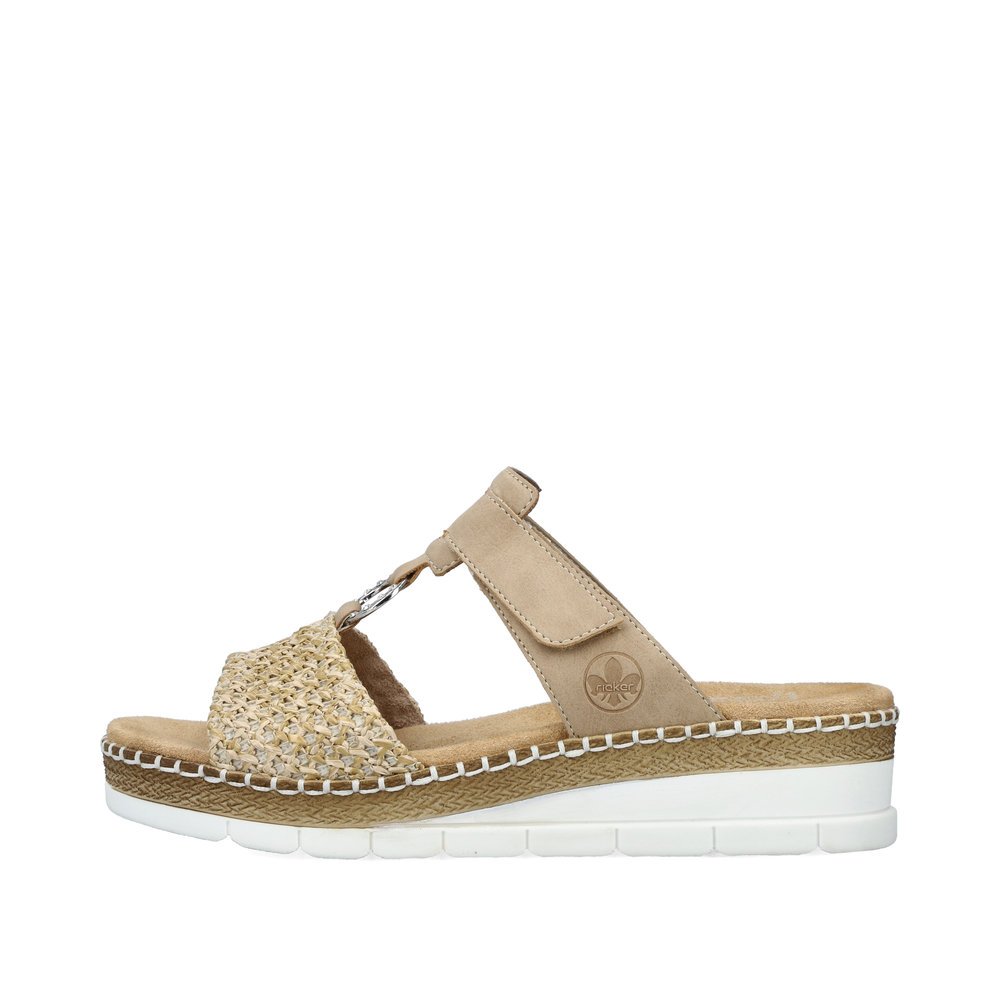 Beige Rieker women´s mules V1243-60 with a hook and loop fastener. Outside of the shoe.