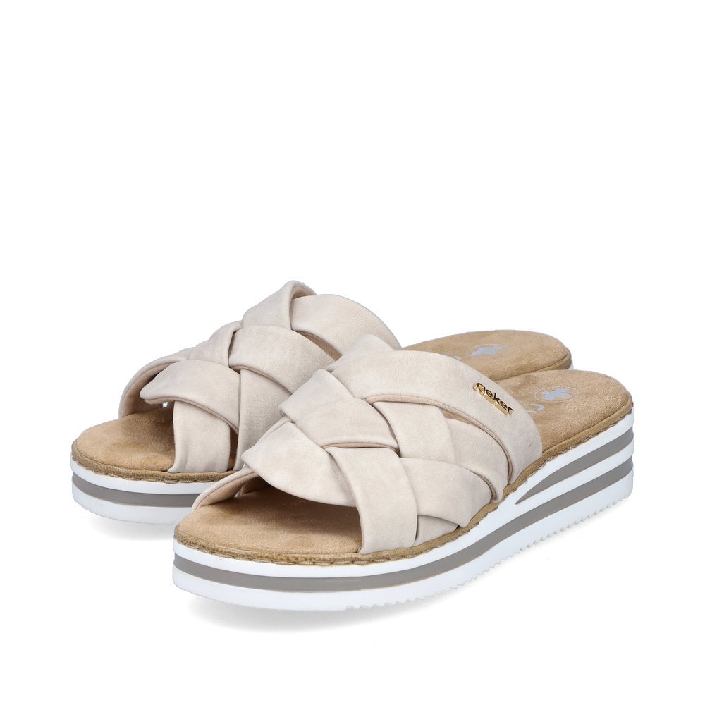 Light beige Rieker women´s mules V0208-60 with the slim fit E 1/2. Shoes laterally.