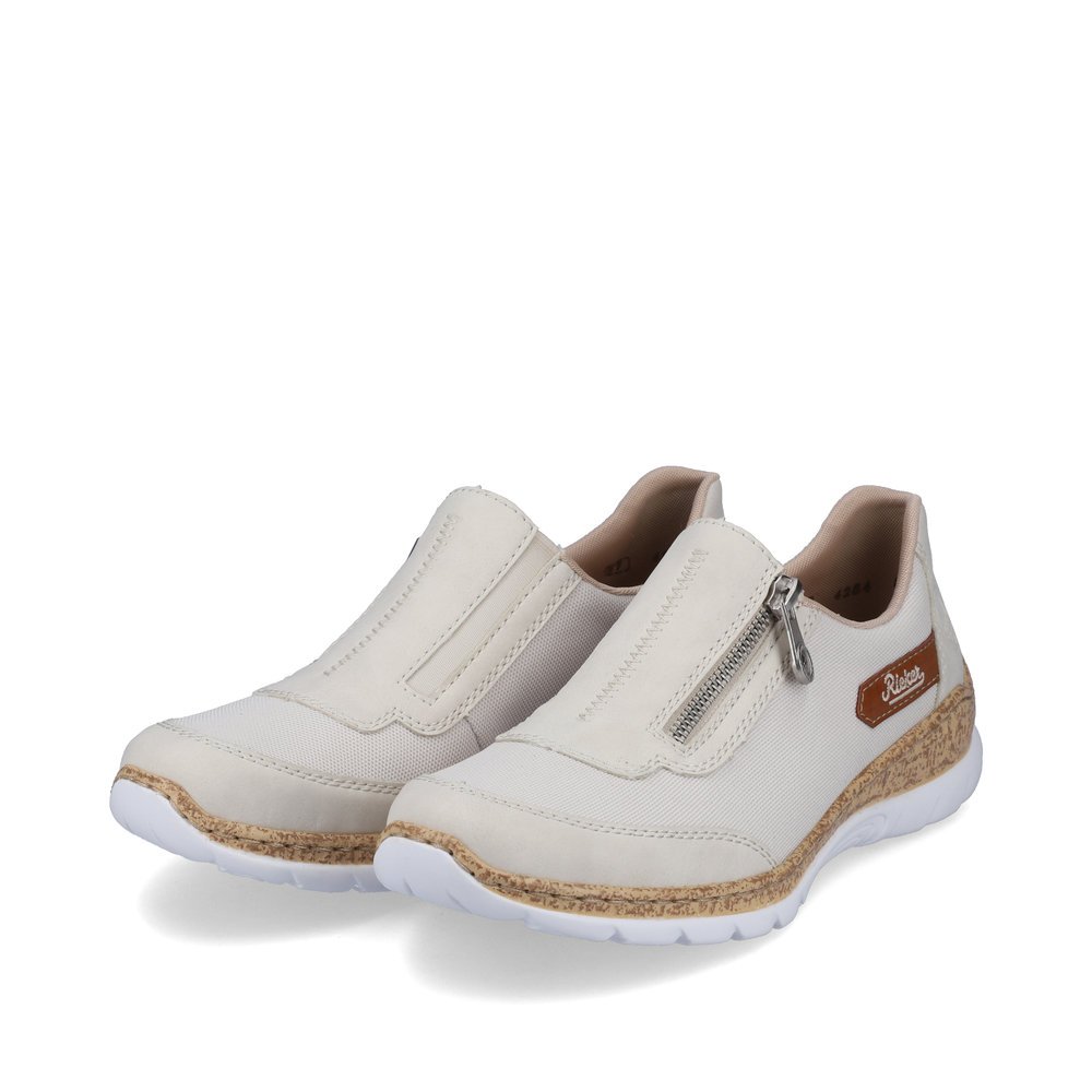 White Rieker women´s slippers N4284-80 with a zipper as well as brown logo. Shoes laterally.