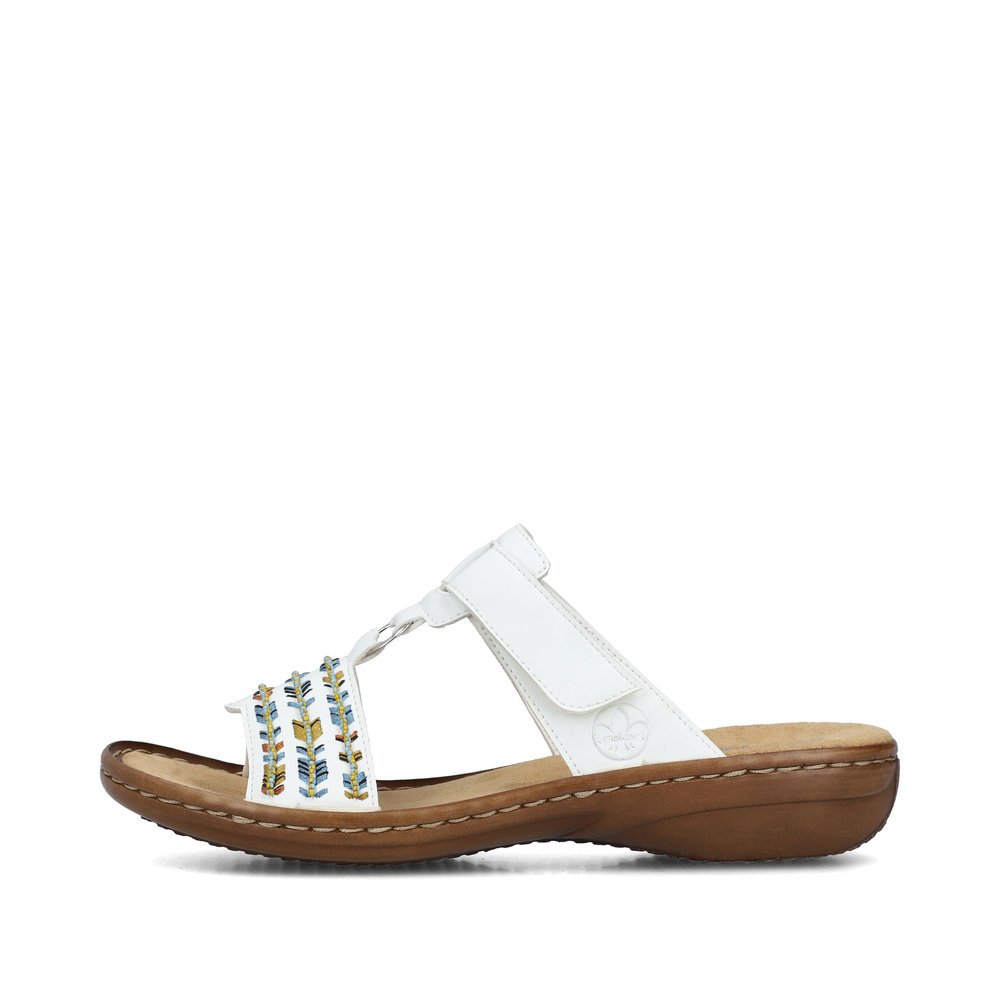 Brilliant white Rieker women´s mules 60867-80 with a hook and loop fastener. Outside of the shoe.