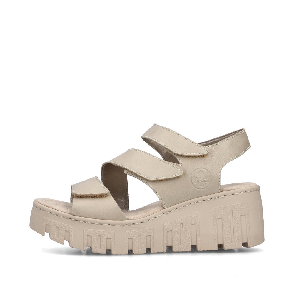 Light beige Rieker women´s wedge sandals 68055-62 with a hook and loop fastener. Outside of the shoe.