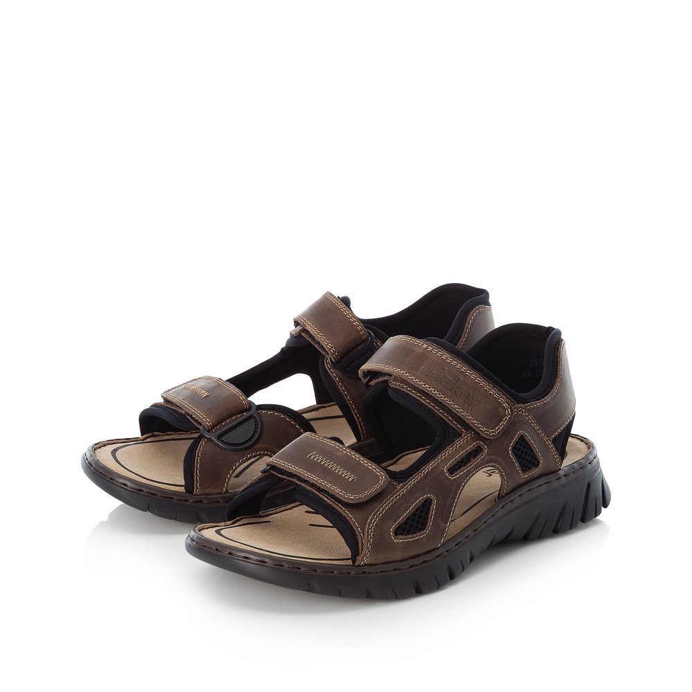 Dark brown Rieker men´s hiking sandals 26761-26 with a hook and loop fastener. Shoes laterally.