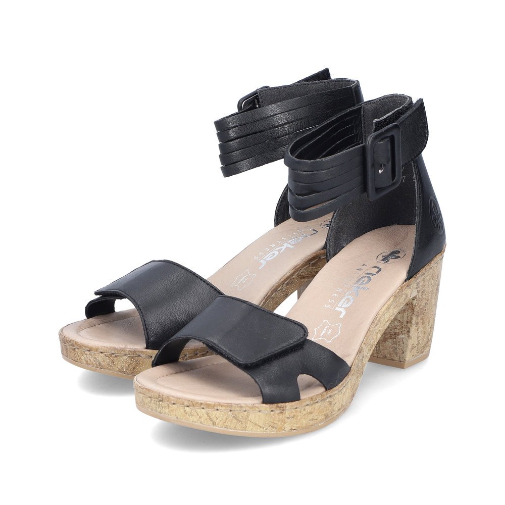 Black Rieker women´s strap sandals 66894-00 with a hook and loop fastener. Shoes laterally.