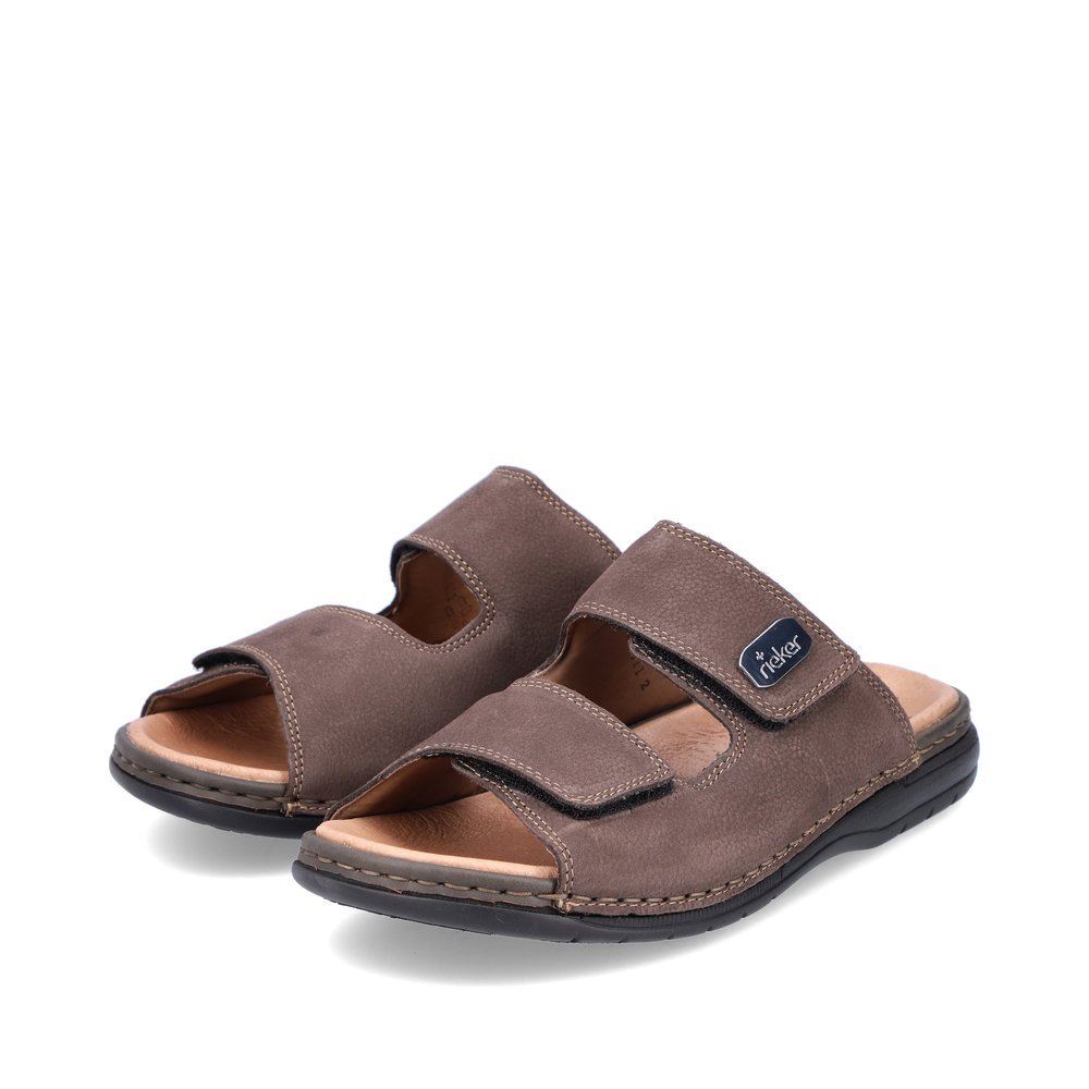 Coffee brown Rieker men´s mules 25590-25 with a hook and loop fastener. Shoes laterally.