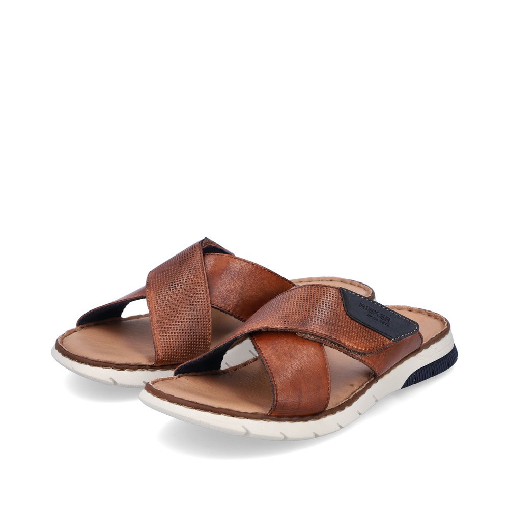Brown Rieker men´s mules 25283-23 with a hook and loop fastener. Shoes laterally.