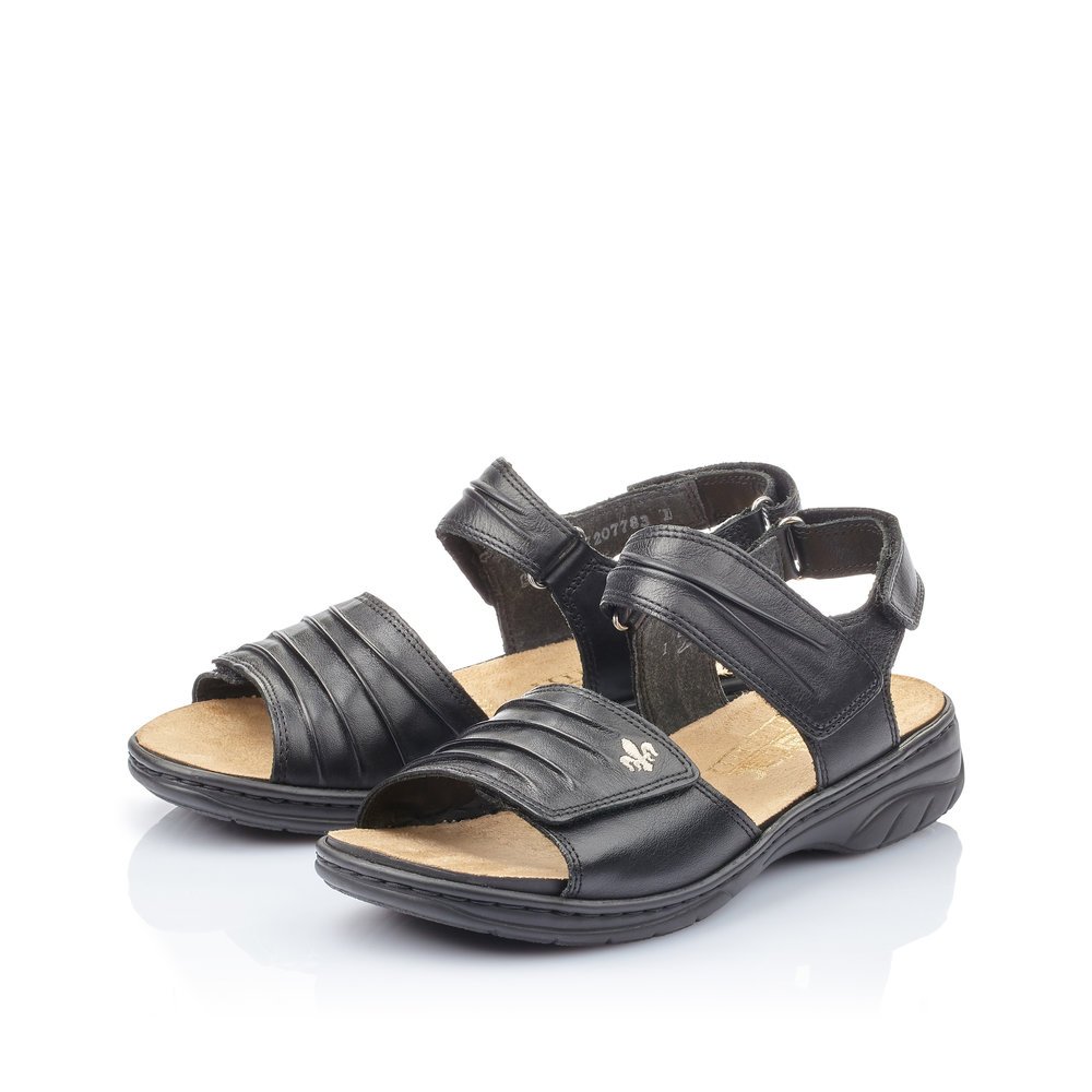 Night black Rieker women´s strap sandals 64560-01 with a hook and loop fastener. Shoes laterally.