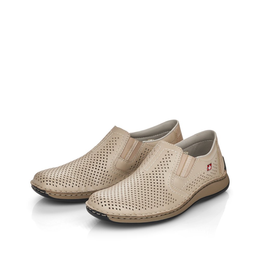 Beige Rieker men´s slippers 05297-60 with elastic insert as well as perforated look. Shoes laterally.