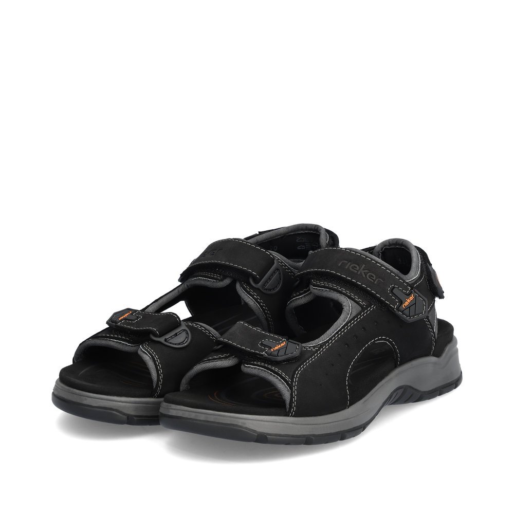 Black Rieker men´s hiking sandals 26951-00 with a hook and loop fastener. Shoes laterally.