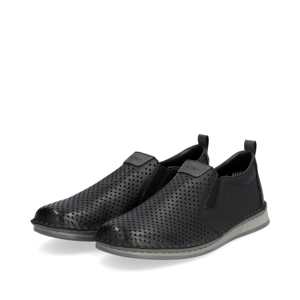 Black Rieker men´s slippers 05457-00 with elastic insert as well as perforated look. Shoes laterally.