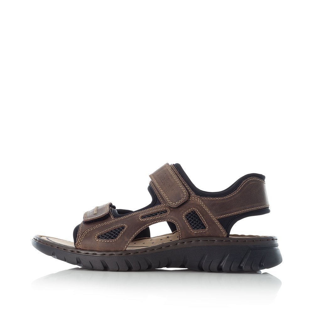 Dark brown Rieker men´s hiking sandals 26761-26 with a hook and loop fastener. Outside of the shoe.