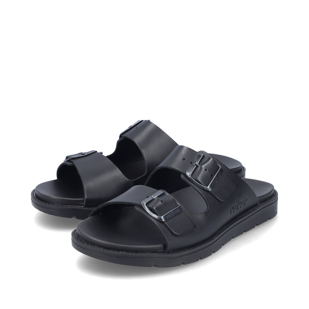 Jet black Rieker men´s mules 24290-00 with buckle as well as comfort width G 1/2. Shoes laterally.
