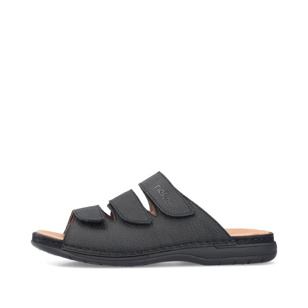Black Rieker men´s mules 25569-00 with a hook and loop fastener. Outside of the shoe.