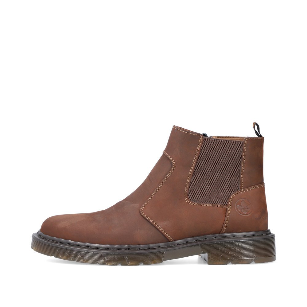 Nougat brown Rieker men´s Chelsea boots 31650-23 with zipper as well as profile sole. The outside of the shoe