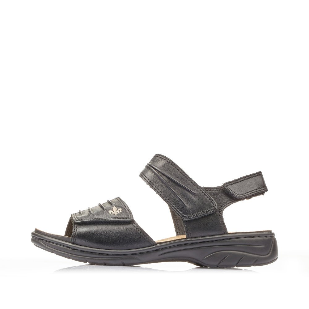 Night black Rieker women´s strap sandals 64560-01 with a hook and loop fastener. Outside of the shoe.