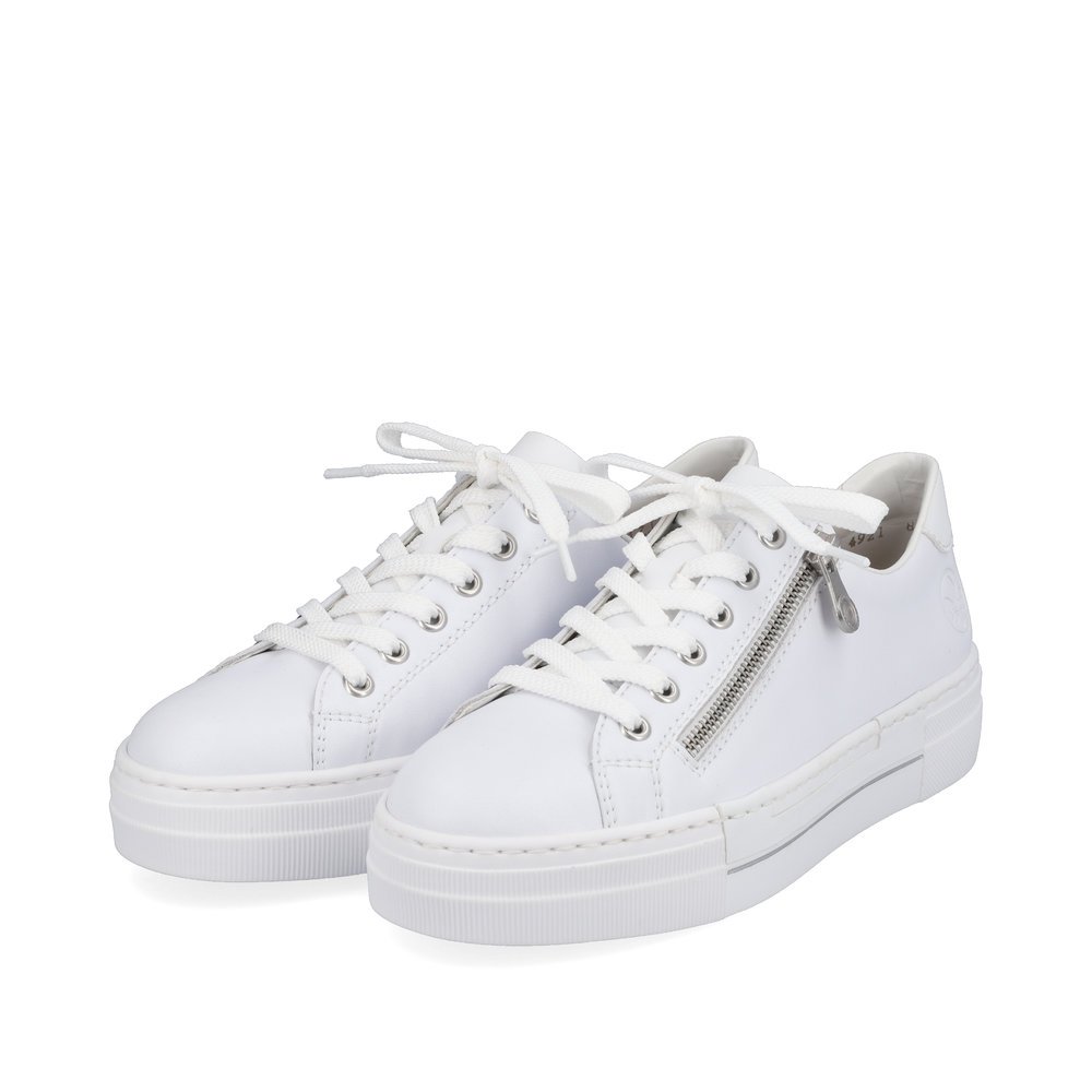 Pure white Rieker women´s low-top sneakers N4921-81 with a zipper. Shoes laterally.
