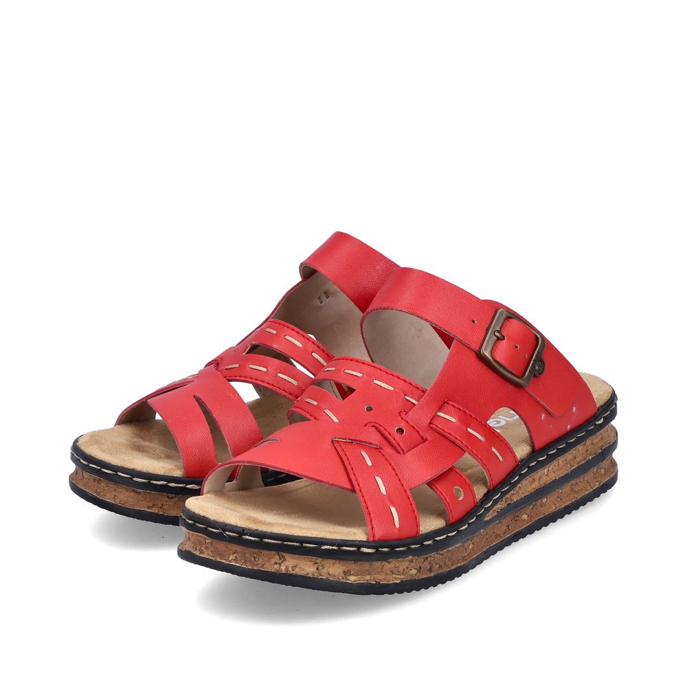 Red Rieker women´s mules 62976-33 with a buckle as well as decorative stitching. Shoes laterally.