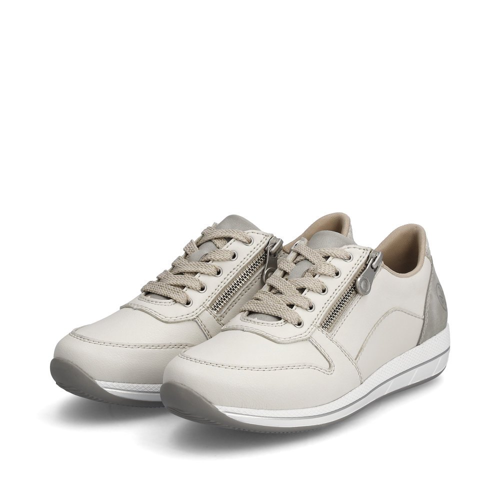 Rieker baskets basses blanches femmes N1100-80 avec une fermeture éclair. Chaussures inclinée sur le côté.