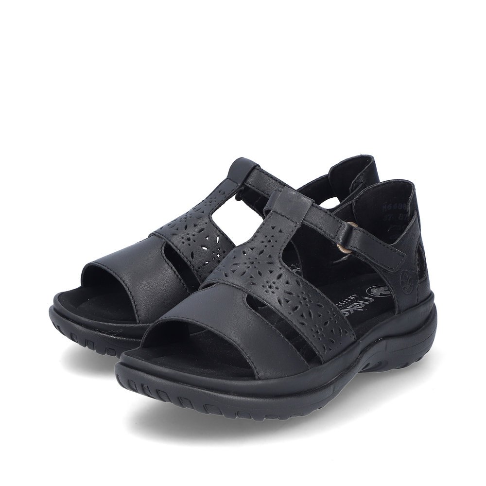 Glossy black Rieker women´s strap sandals 64865-01 with a hook and loop fastener. Shoes laterally.