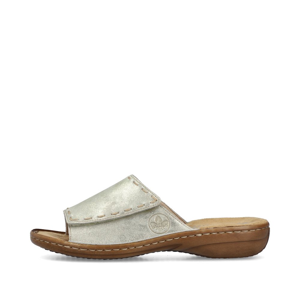 Light beige Rieker women´s mules 60896-62 with a hook and loop fastener. Outside of the shoe.