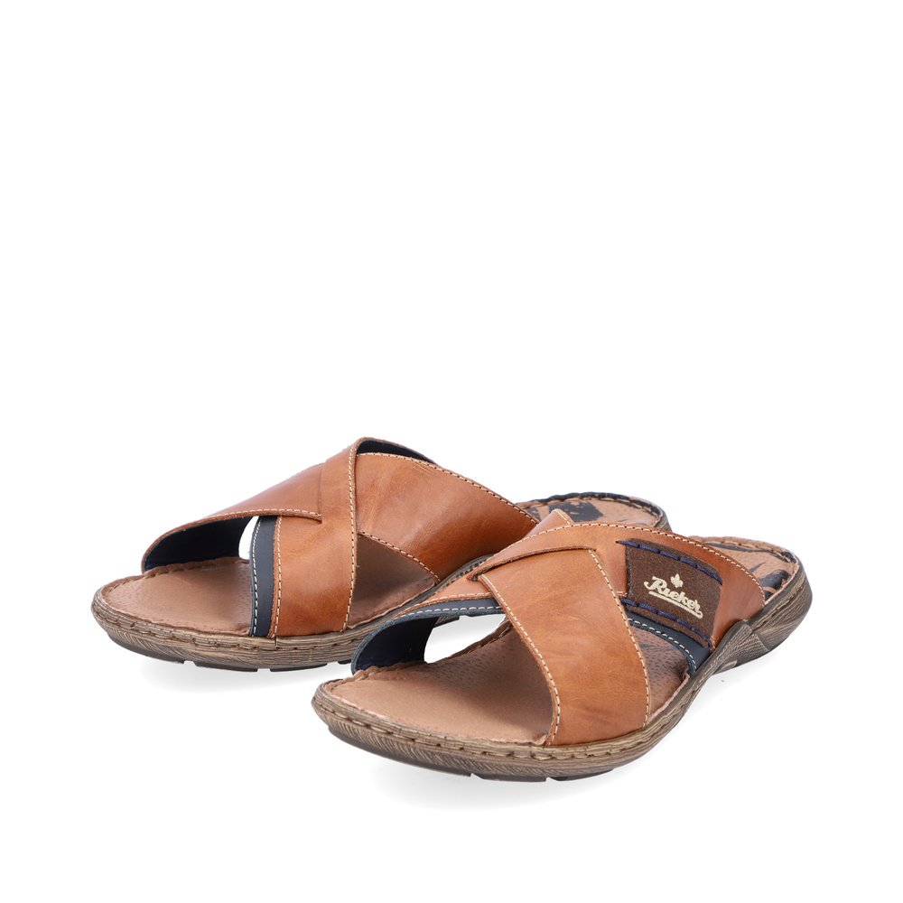 Brown Rieker men´s mules 22099-25 with comfort width G 1/2 as well as a light sole. Shoes laterally.
