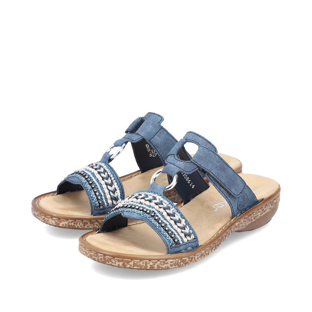 Denim blue Rieker women´s mules 628M6-14 with a hook and loop fastener. Shoes laterally.