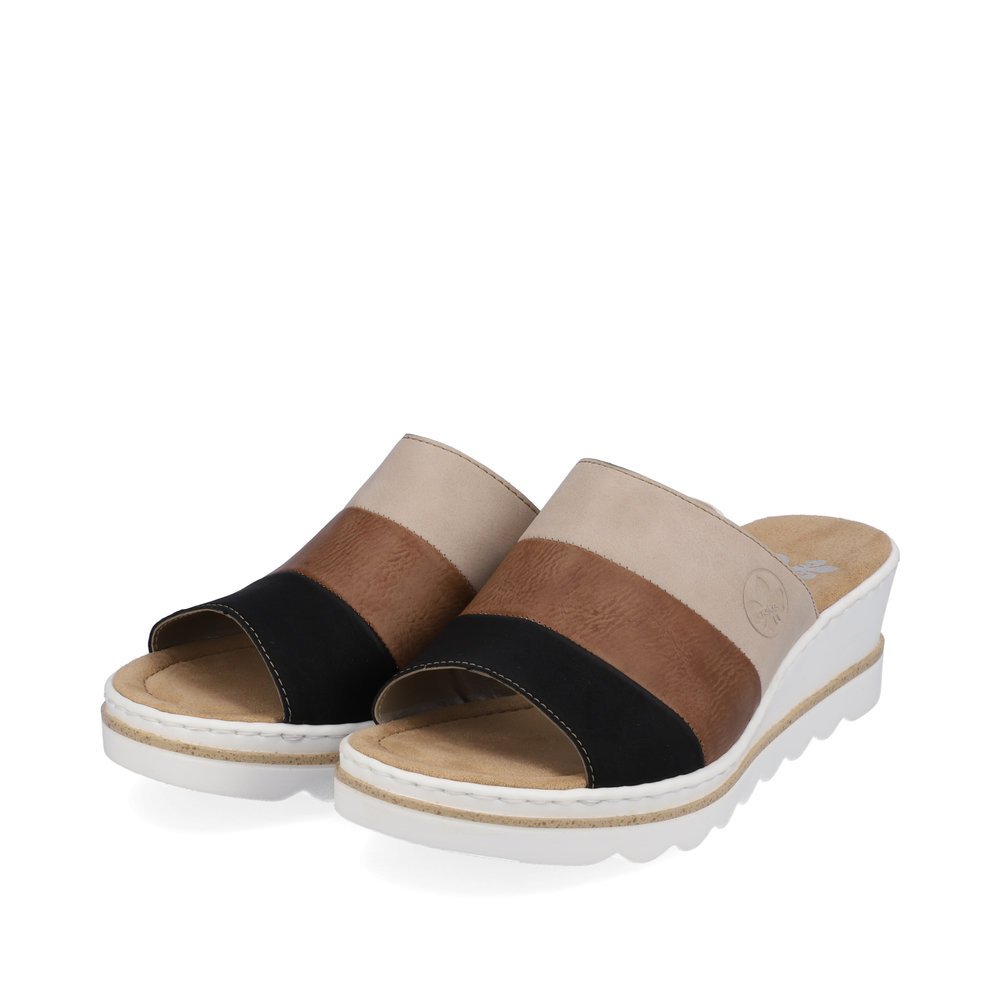 Brown Rieker women´s mules 67492-64 with very light sole with wedge heel as well as. Shoes laterally.