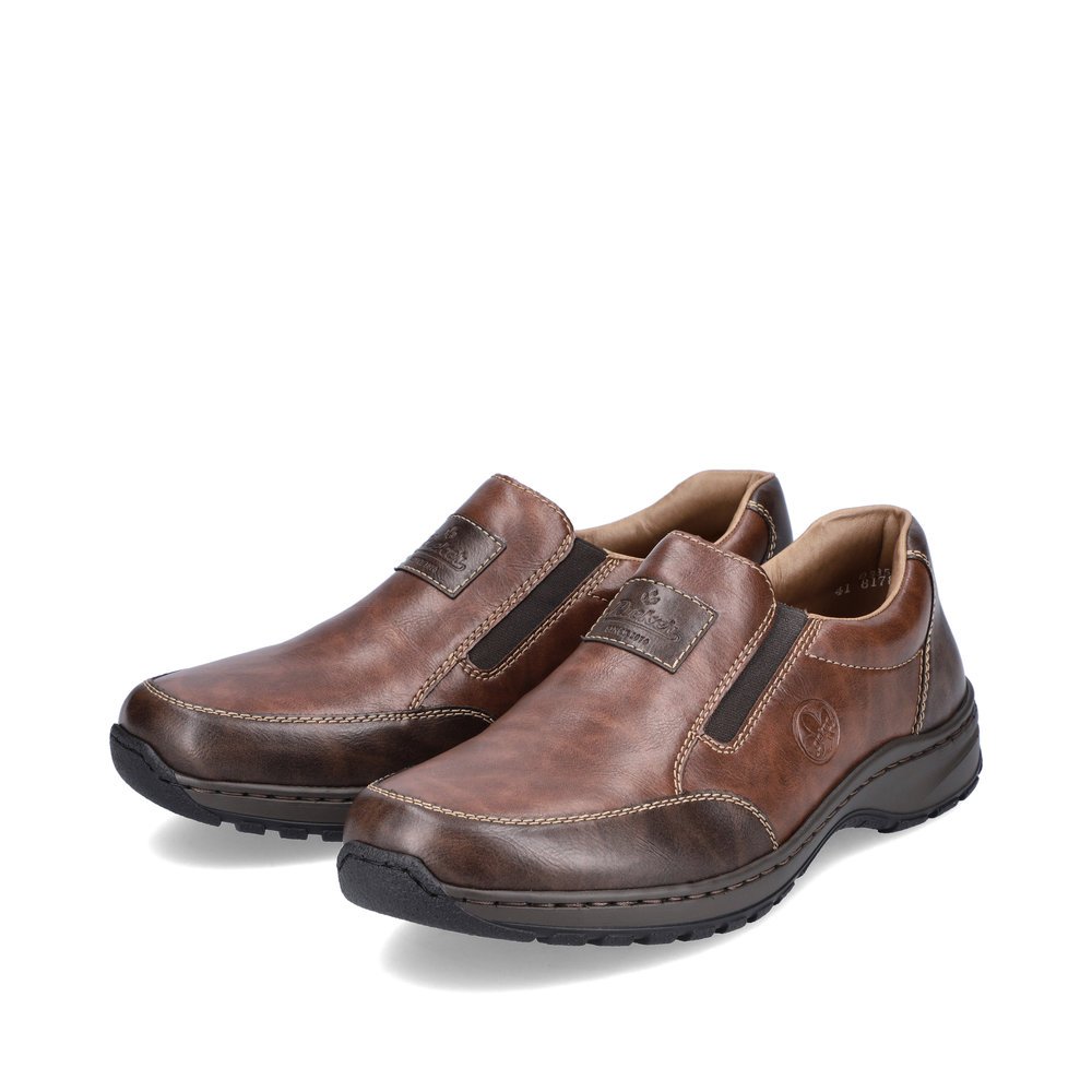 Brown Rieker men´s slippers 03354-26 with elastic insert as well as extra width H. Shoes laterally.