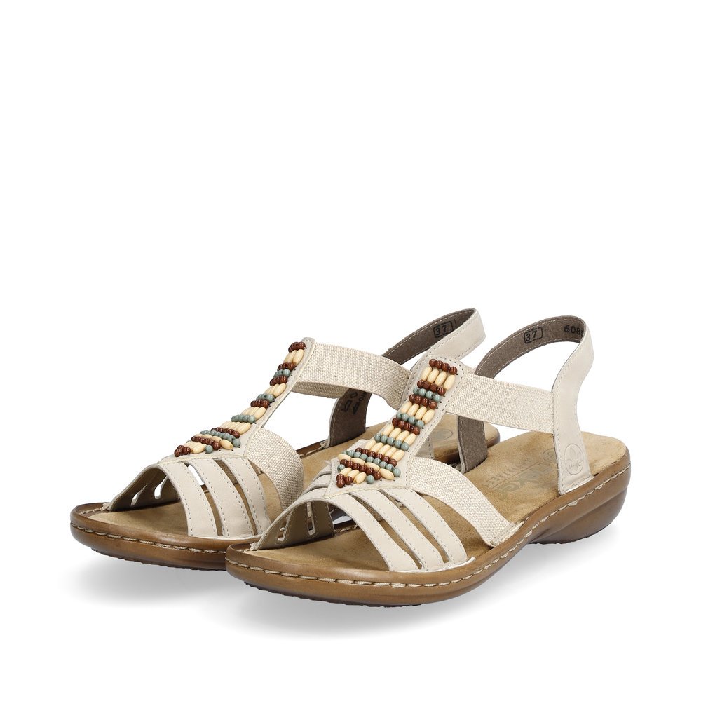 Light beige Rieker women´s strap sandals 60851-62 with an elastic insert. Shoes laterally.
