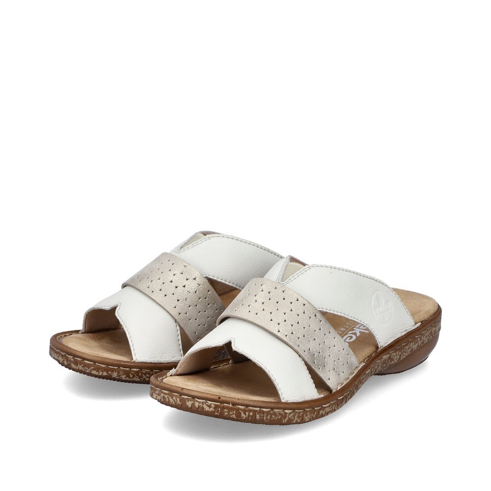 White Rieker women´s mules 62897-80 in perforated look as well as slim fit E 1/2. Shoes laterally.
