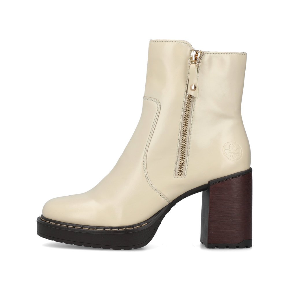 Vanilla beige Rieker women´s ankle boots Y4155-60 with zipper as well as block heel. The outside of the shoe